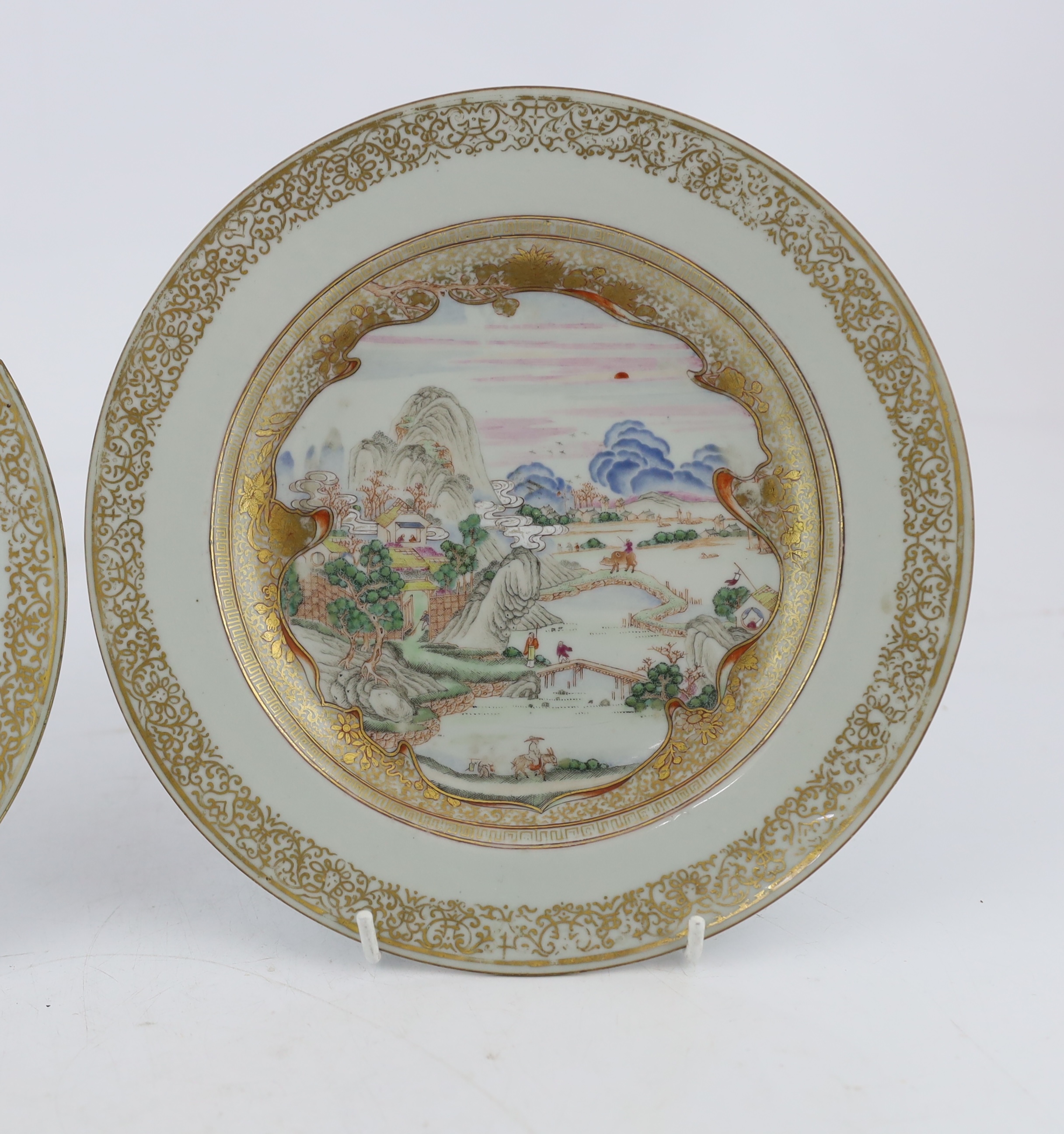 A pair of Chinese famille rose ‘landscape’ plates, Yongzheng-Qianlong period, small edge chip